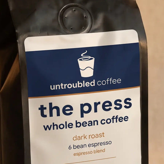the press whole bean coffee, black bag with navy and cream label