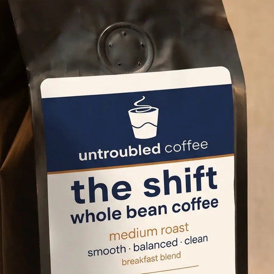 the shift whole bean coffee, black bag with navy and cream label